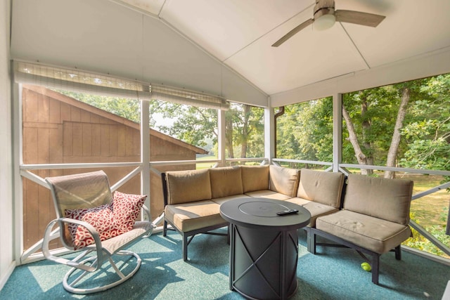 sunroom / solarium with lofted ceiling, ceiling fan, and a healthy amount of sunlight