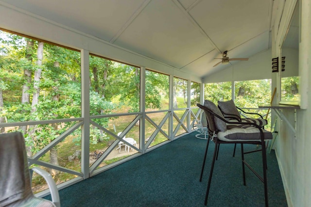 sunroom featuring lofted ceiling and ceiling fan