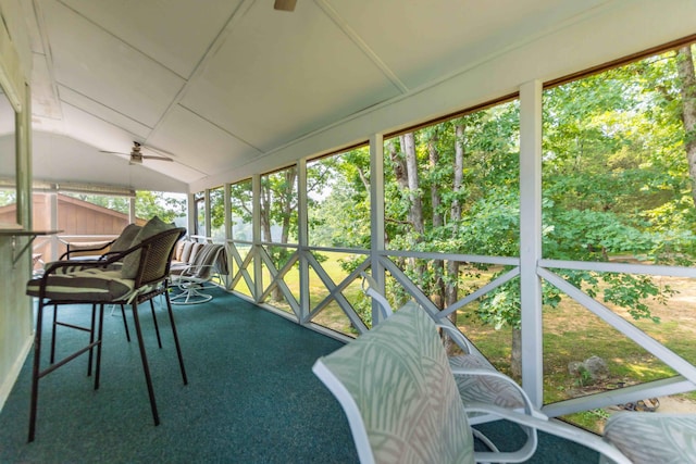 sunroom / solarium with lofted ceiling and ceiling fan