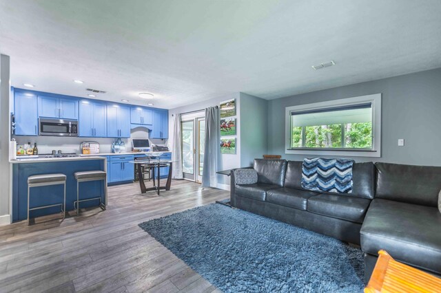 living room with light hardwood / wood-style flooring