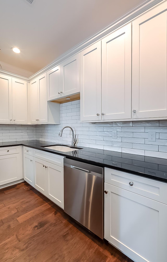 kitchen featuring backsplash, sink, dishwasher, dark hardwood / wood-style floors, and white cabinetry