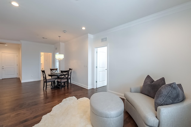 living room featuring crown molding and dark wood-type flooring