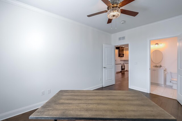 bedroom with ensuite bathroom, dark hardwood / wood-style floors, crown molding, and ceiling fan