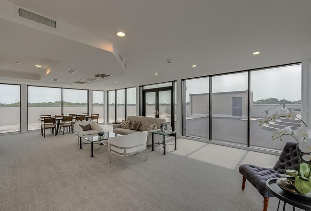 living room with light colored carpet and a water view