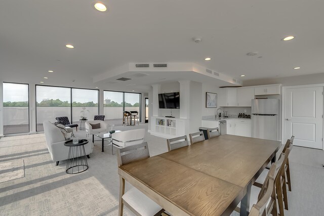 dining room featuring light carpet