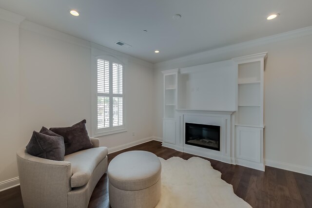 sitting room featuring dark hardwood / wood-style flooring and ornamental molding