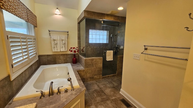 bathroom featuring tile patterned flooring, plenty of natural light, and independent shower and bath