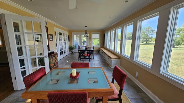 sunroom / solarium with a healthy amount of sunlight and french doors