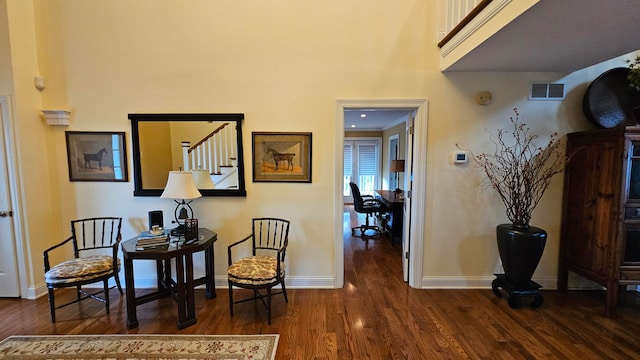 sitting room with dark wood-type flooring