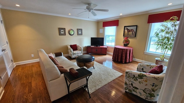 living room with ornamental molding, hardwood / wood-style flooring, a healthy amount of sunlight, and ceiling fan