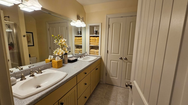 bathroom featuring tile patterned flooring, toilet, and vanity