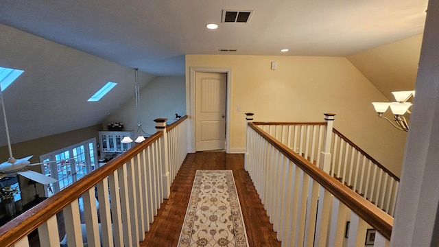 hallway featuring vaulted ceiling and dark hardwood / wood-style flooring