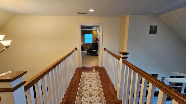 hall with dark hardwood / wood-style flooring and lofted ceiling