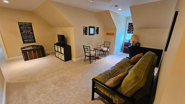 living room with ceiling fan, light carpet, and vaulted ceiling