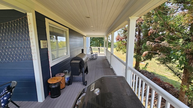 wooden deck featuring area for grilling and covered porch