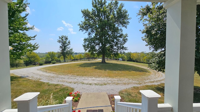 exterior space featuring a lawn and a rural view