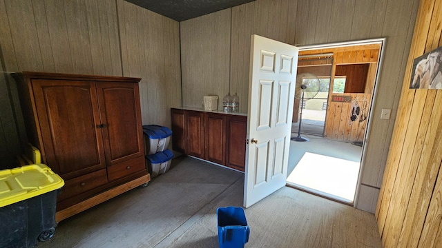 interior space with hardwood / wood-style floors and wooden walls