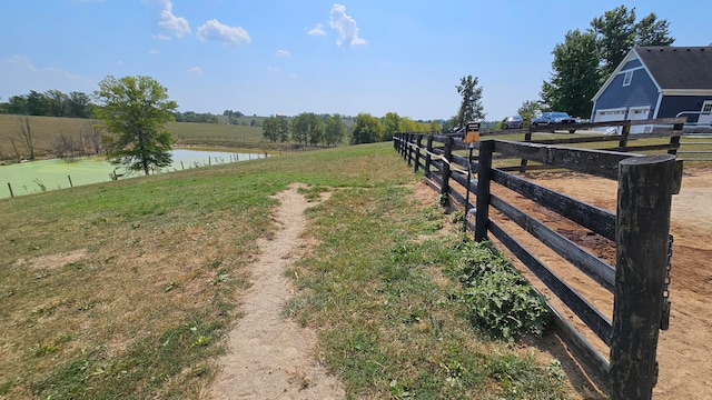 view of road featuring a water view and a rural view