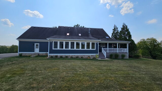 rear view of property with a lawn and a porch