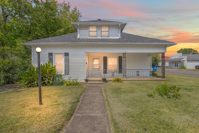 bungalow-style home featuring a lawn and a porch