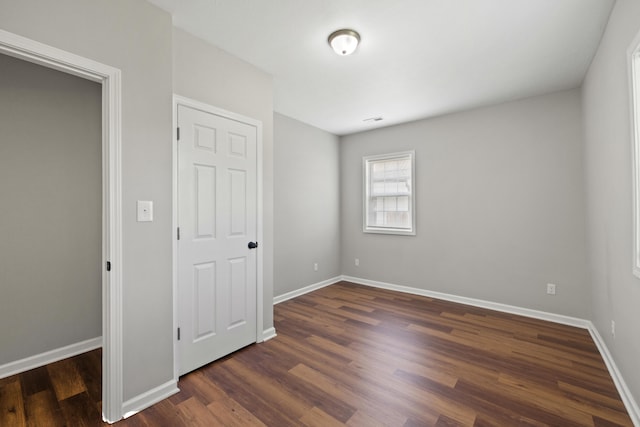 unfurnished bedroom featuring dark hardwood / wood-style flooring