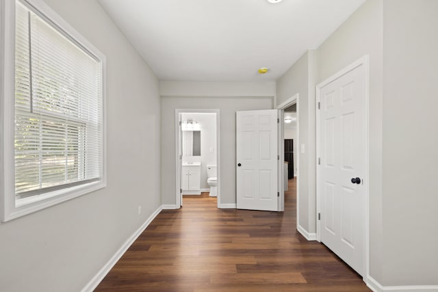 interior space featuring dark wood-type flooring and ensuite bathroom