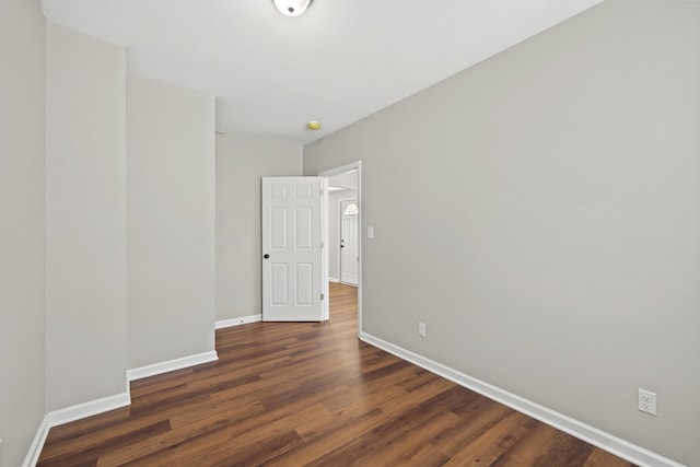 spare room featuring dark wood-type flooring