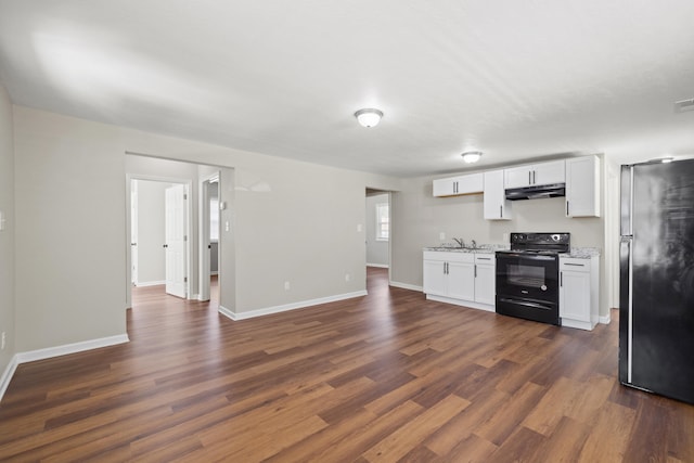 kitchen with black range with electric stovetop, dark wood-type flooring, stainless steel fridge, and white cabinetry