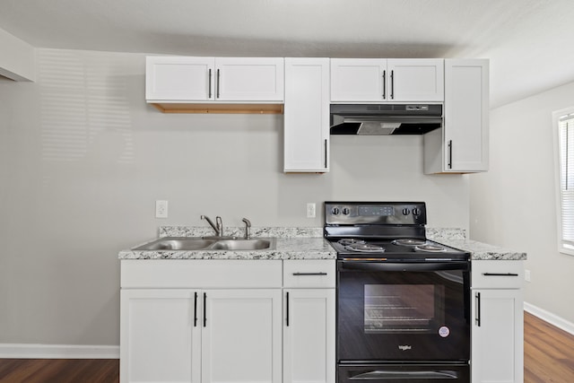 kitchen with black range with electric stovetop, sink, and white cabinets