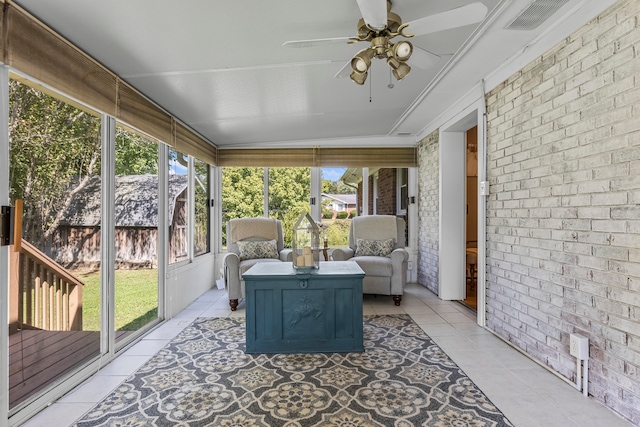 sunroom featuring ceiling fan and a wealth of natural light