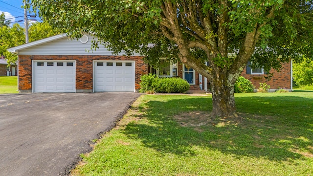 view of front of property with a garage and a front lawn