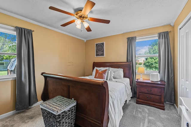 bedroom with light carpet, crown molding, a textured ceiling, ceiling fan, and a closet