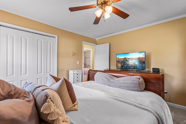 bedroom featuring crown molding, a closet, ceiling fan, and carpet floors