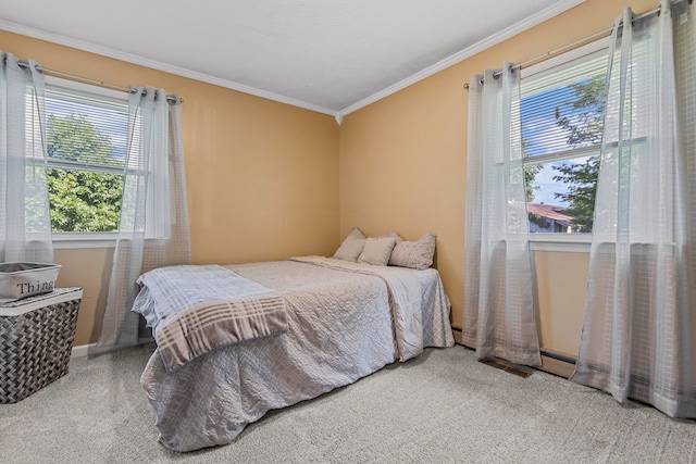 carpeted bedroom with a baseboard heating unit and ornamental molding