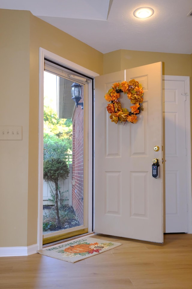 entryway with visible vents, baseboards, and light wood-style floors