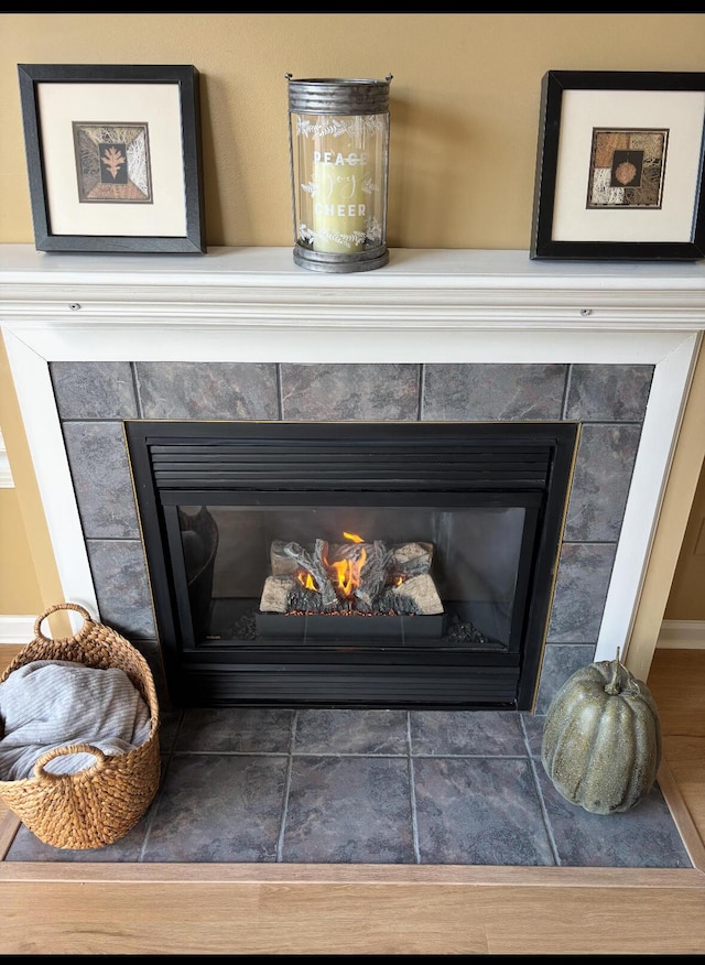 interior details with a tile fireplace