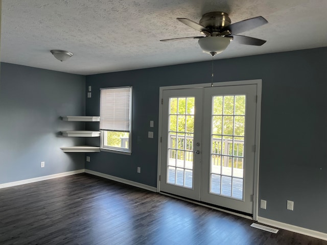 interior space featuring a wealth of natural light, ceiling fan, dark hardwood / wood-style floors, and french doors