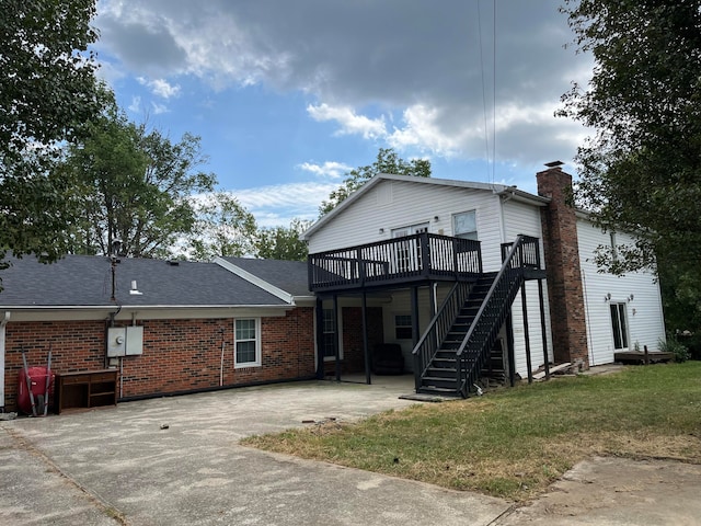 back of house with a lawn, a patio area, and a deck