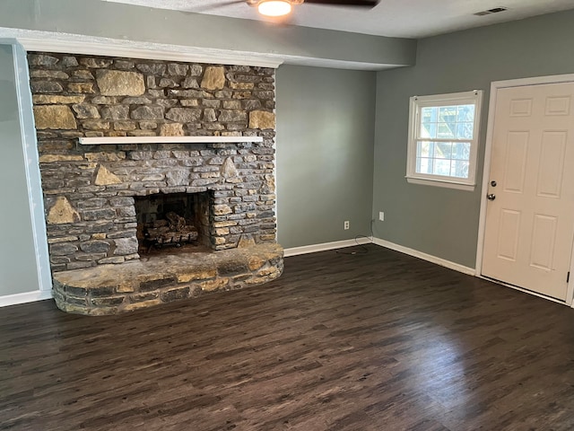 unfurnished living room featuring ceiling fan, a fireplace, and dark hardwood / wood-style floors