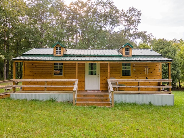 log home with a porch and a front yard