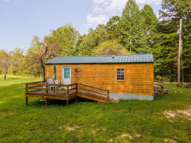 rear view of house featuring a yard and a deck