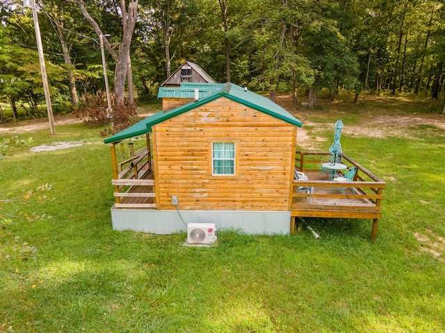 view of side of home with an outdoor structure and a lawn