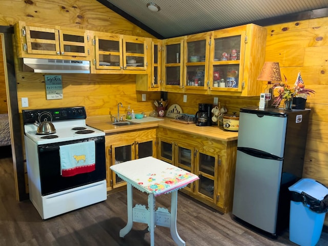 kitchen with dark hardwood / wood-style flooring, stainless steel refrigerator, wooden walls, and white electric range