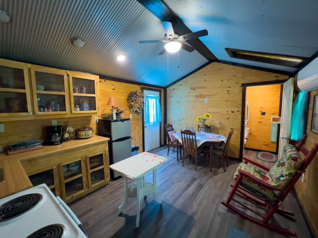 interior space with lofted ceiling, dark wood-type flooring, ceiling fan, and wooden walls