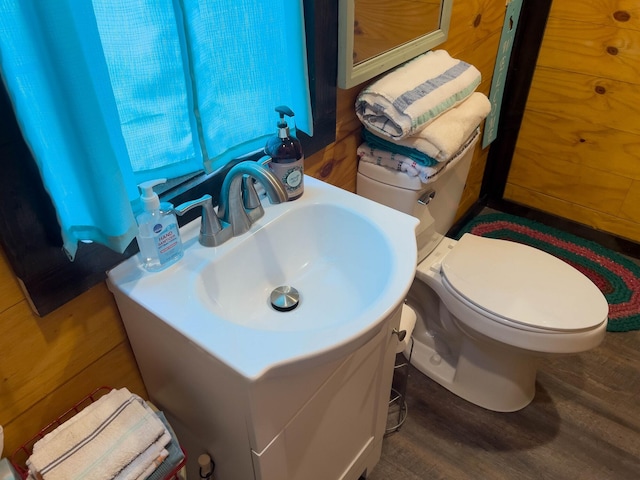 bathroom with vanity, toilet, and hardwood / wood-style floors