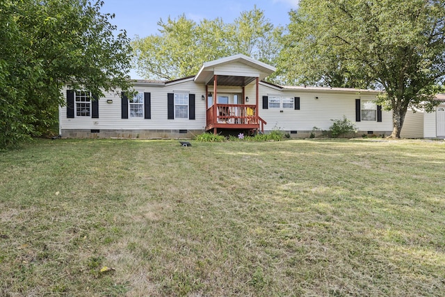 view of front of home with a deck and a front yard