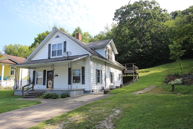 view of front of property with covered porch and a front yard