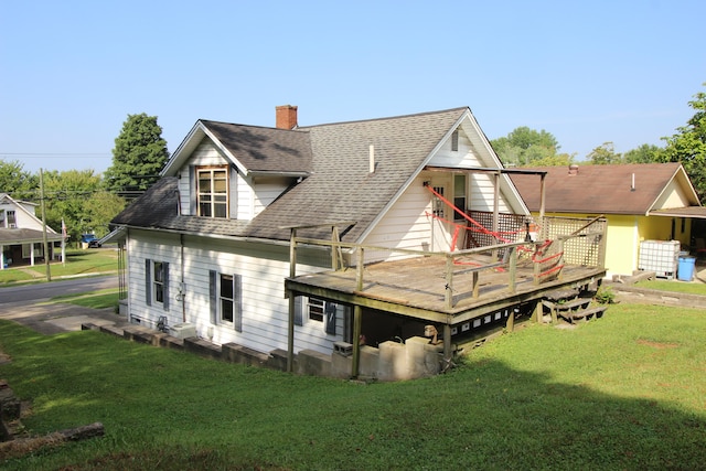 back of house with a wooden deck and a yard