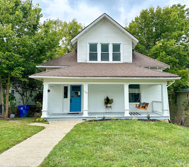 view of front of house with a front yard and a porch