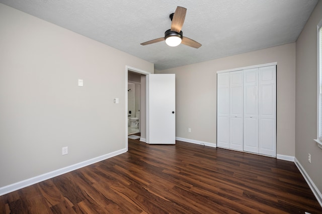 unfurnished bedroom featuring a textured ceiling, dark wood-type flooring, ceiling fan, and a closet